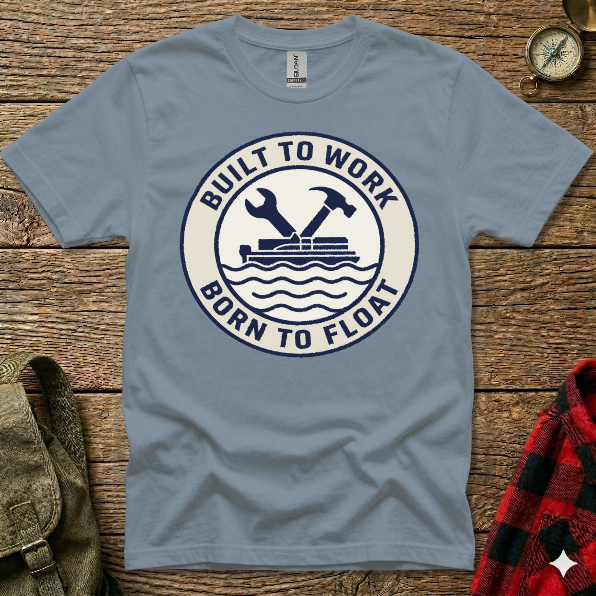 Blue t-shirt with "Built to Work Born to Float" circular logo featuring tools and waves.