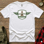White t-shirt with green shield logo featuring a tree, anvil, and "Frontier Quality Blue Collar Roots" text.
