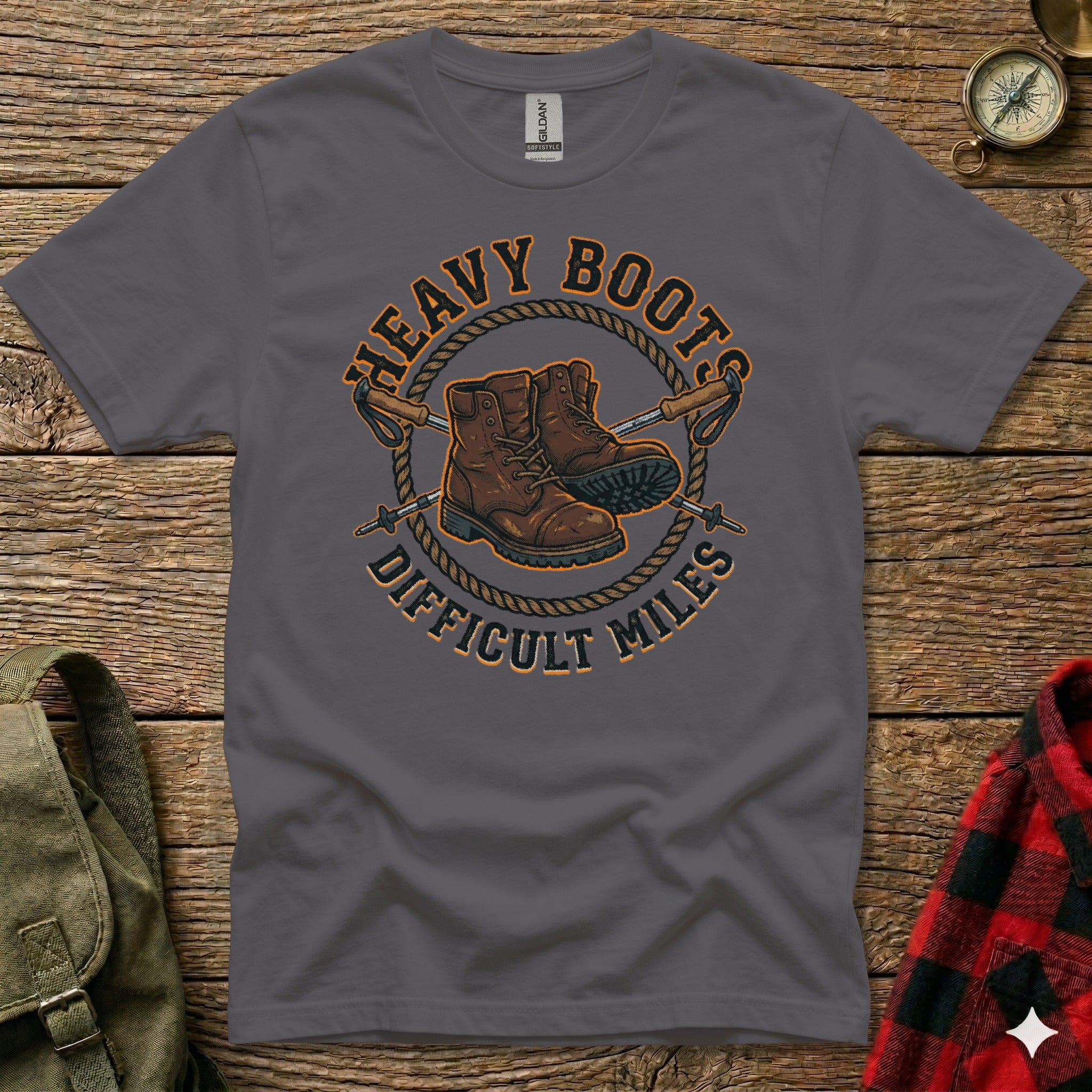 Dark grey t-shirt with "Heavy Boots Difficult Miles" and hiking boot graphic.