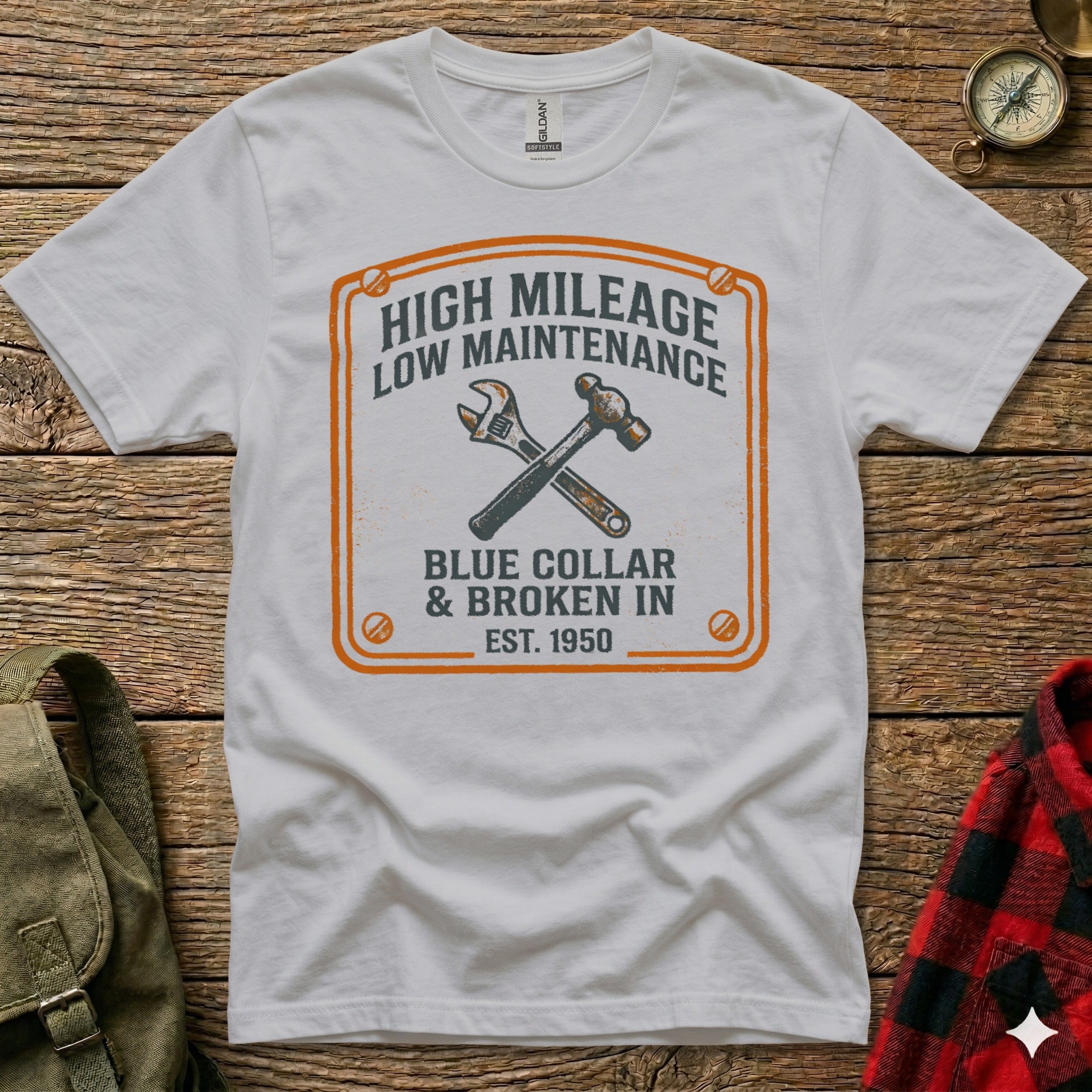 T-shirt with "High Mileage, Low Maintenance, Blue Collar & Broken In" text and tools.
