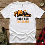 White t-shirt with orange mountain and wrench graphic, "Built for the Grade" text.