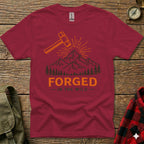 Maroon t-shirt with mountain and "Forged In The Wild" text graphic.