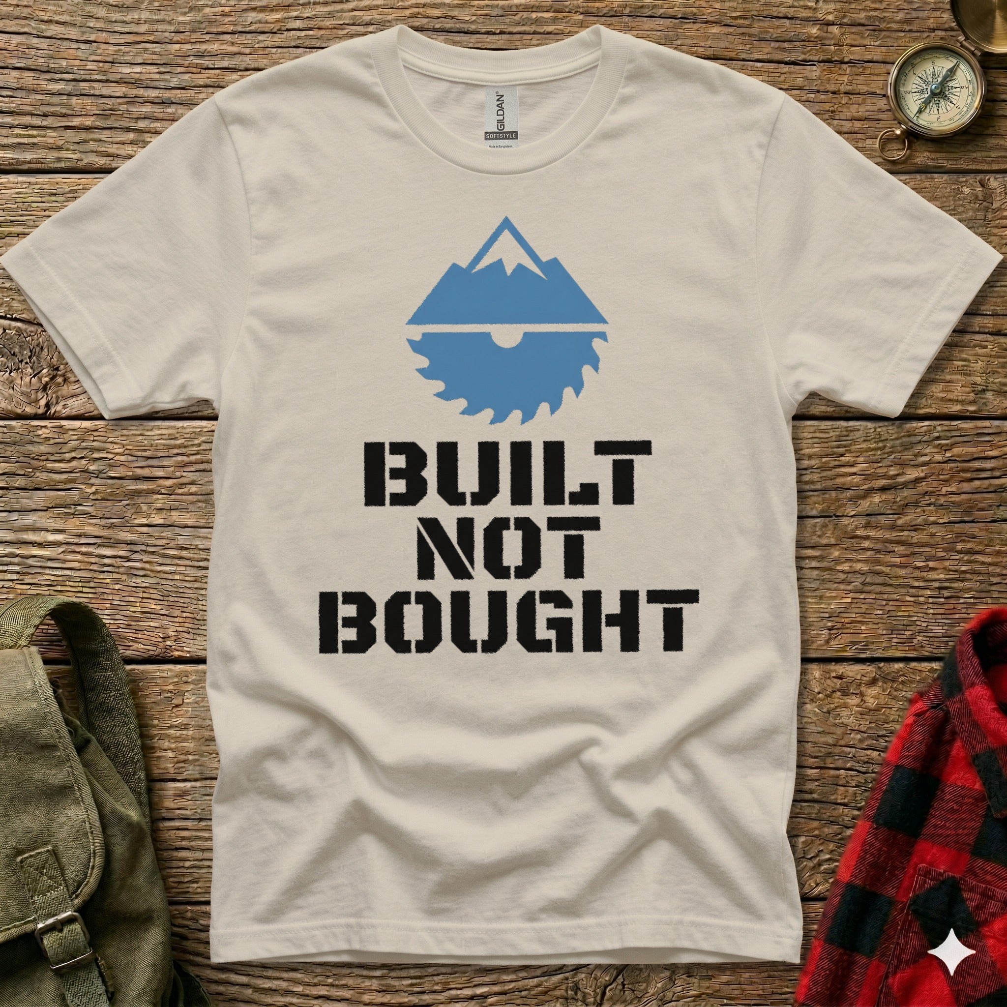 T-shirt with mountain and saw graphic, text "BUILT NOT BOUGHT".
