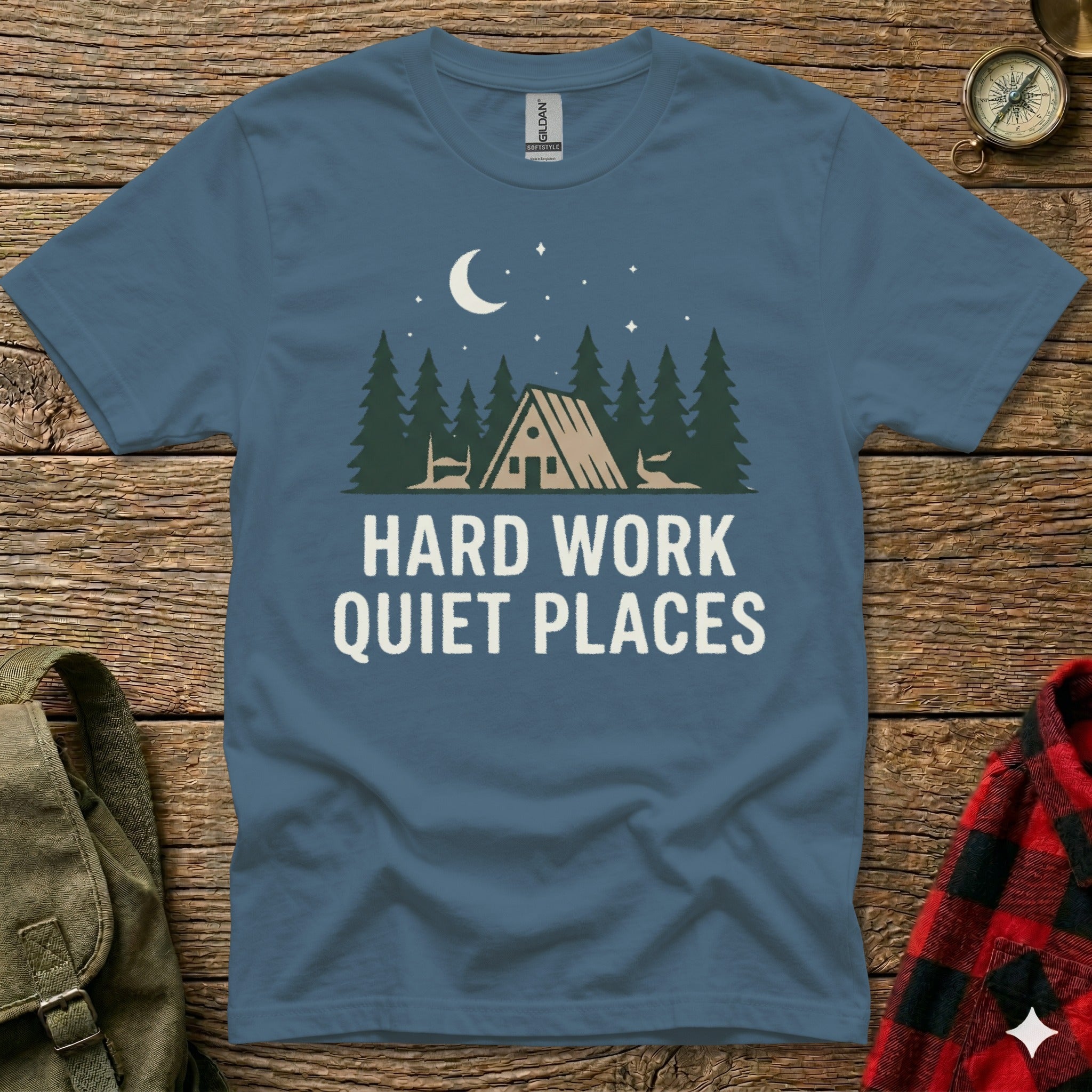 T-shirt with a forest scene, moon, stars, and text "Hard Work Quiet Places".