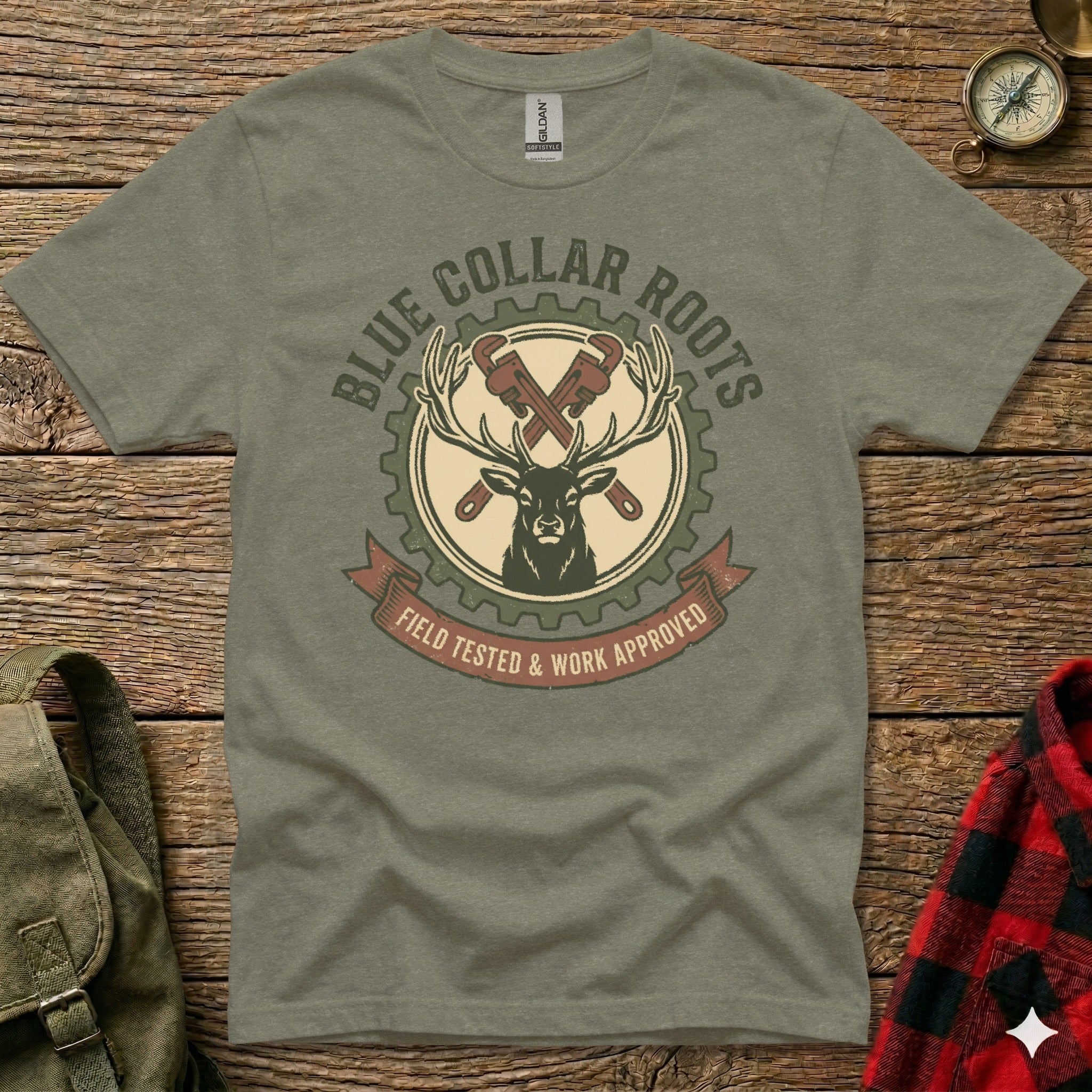 Green t-shirt with deer, gears, and tools graphic, "Blue Collar Roots Field Tested & Work Approved".