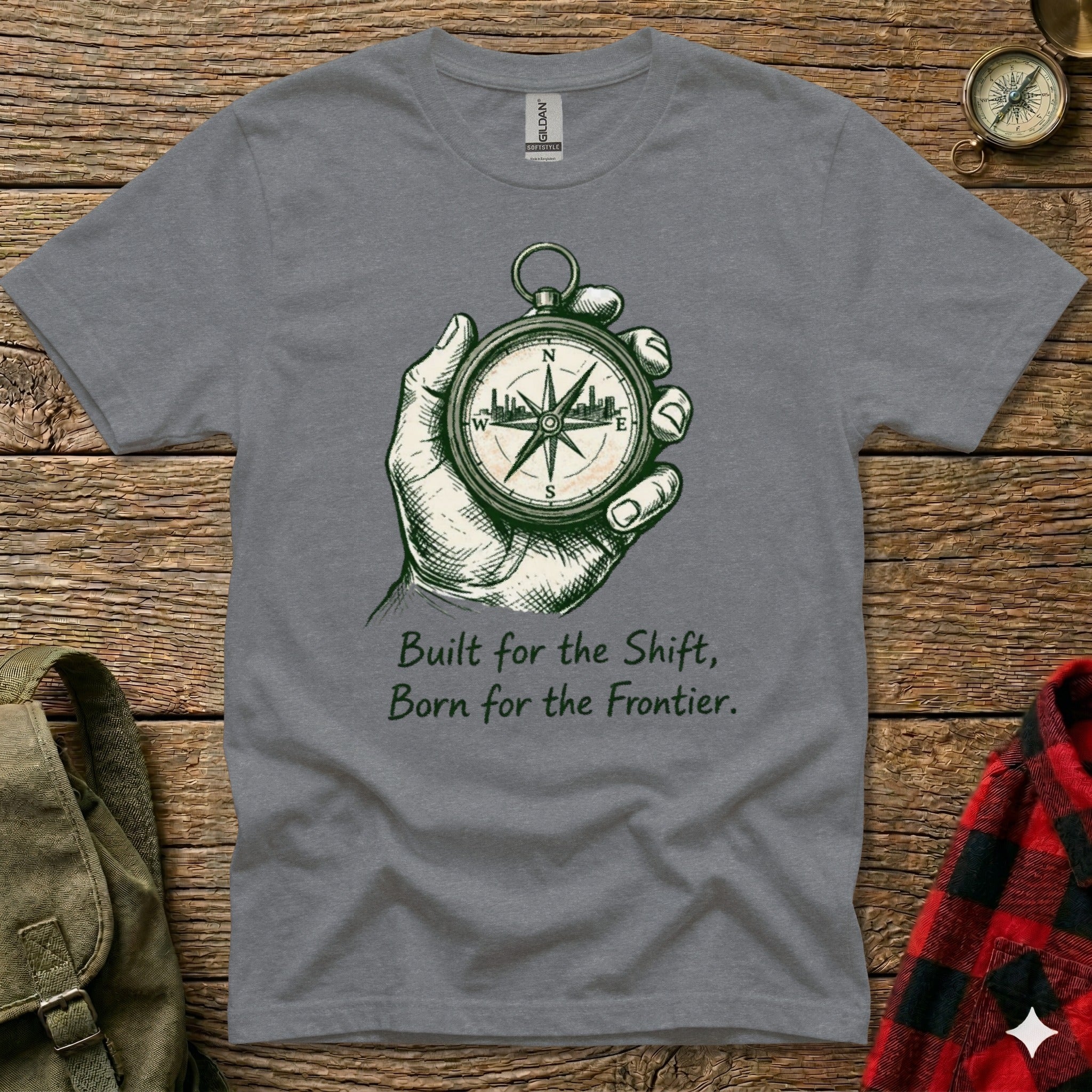 Gray t-shirt with compass graphic and text "Built for the Shift, Born for the Frontier."