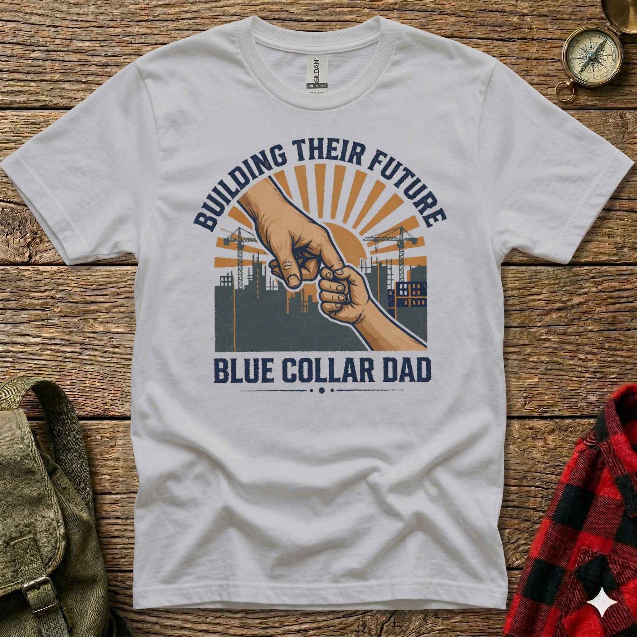 White t-shirt with "BUILDING THEIR FUTURE BLUE COLLAR DAD" text and construction graphic.