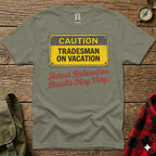 Green t-shirt with yellow "CAUTION TRADESMAN ON VACATION" sign and red text.