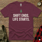 Maroon t-shirt with white text "SHIFT ENDS. LIFE STARTS." and a green tree graphic.