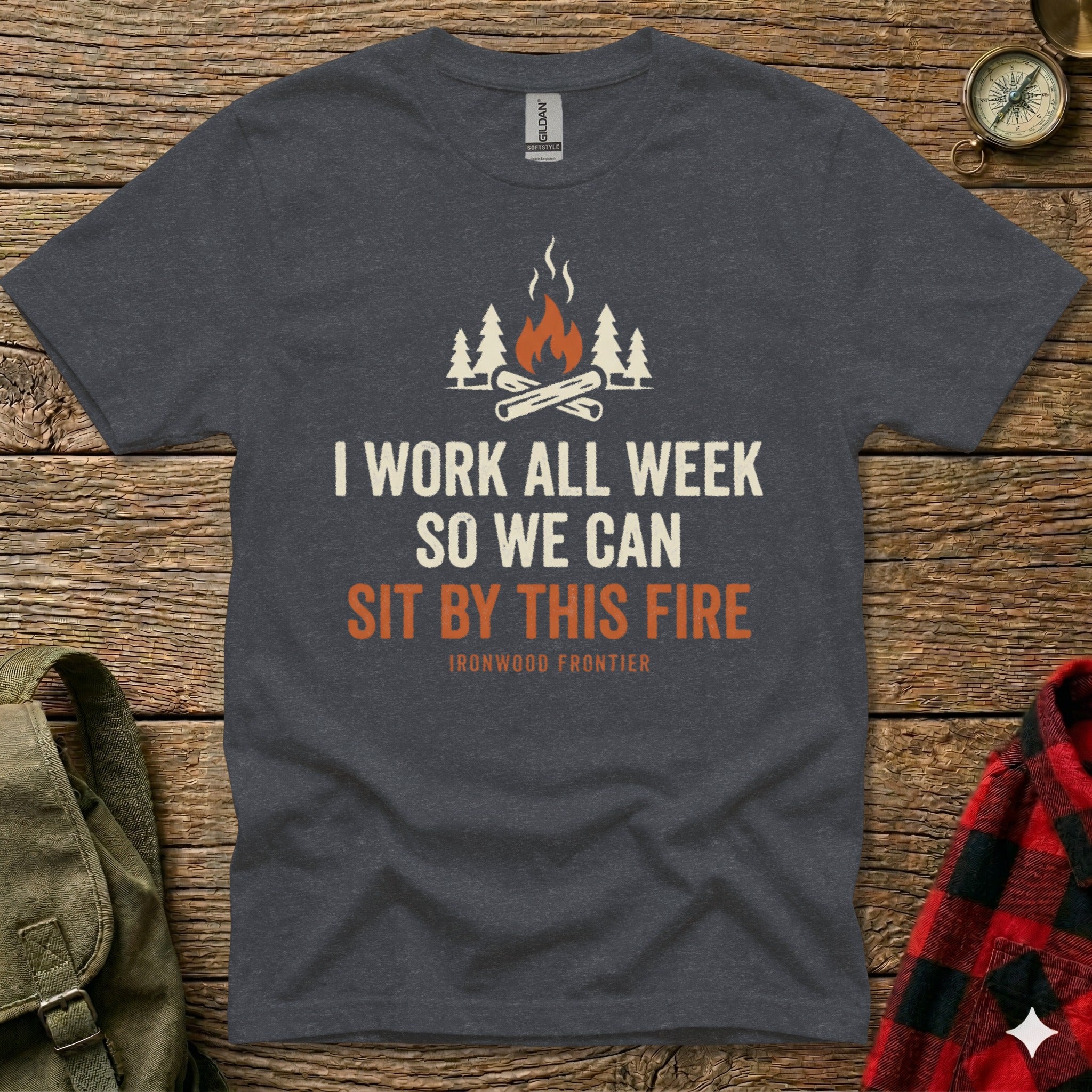 Dark t-shirt with text "I WORK ALL WEEK SO WE CAN SIT BY THIS FIRE" and a campfire graphic.