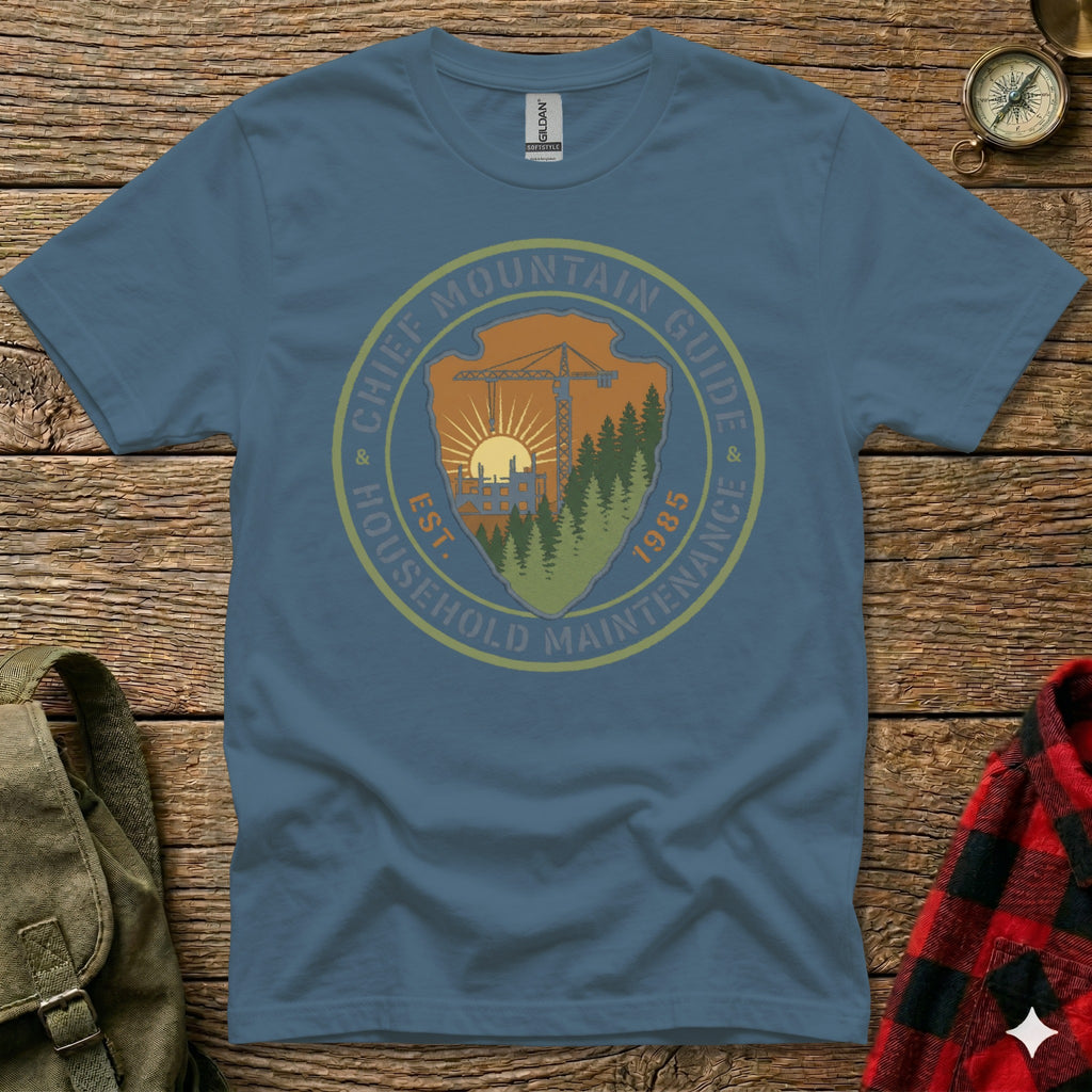 Blue t-shirt with "Chief Mountain Guide Household Maintenance" circular logo and "Est. 1985".