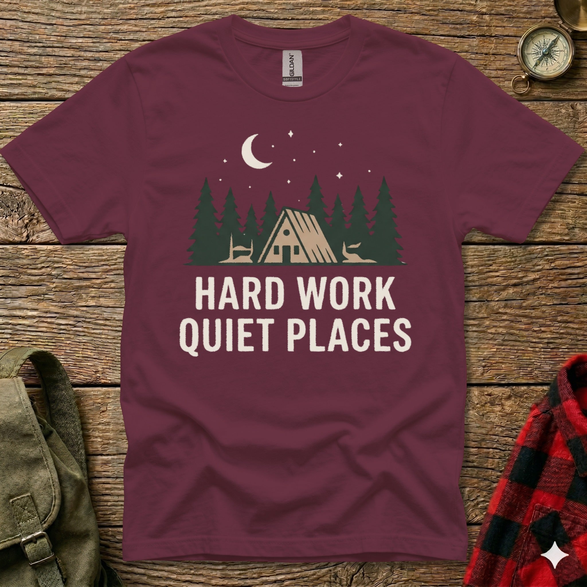 Maroon t-shirt with "HARD WORK QUIET PLACES" text and forest scene graphic.