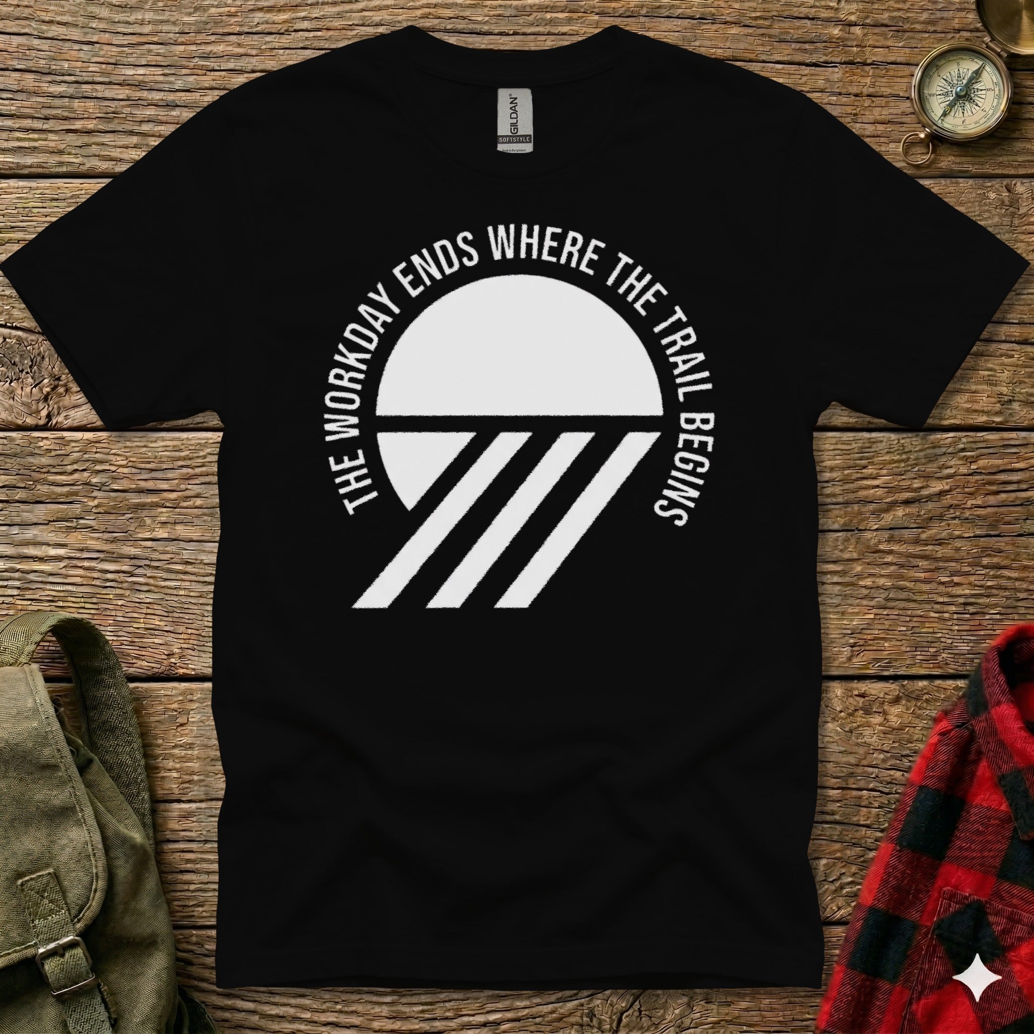 Black t-shirt with "The workday ends where the trail begins" text and geometric design.