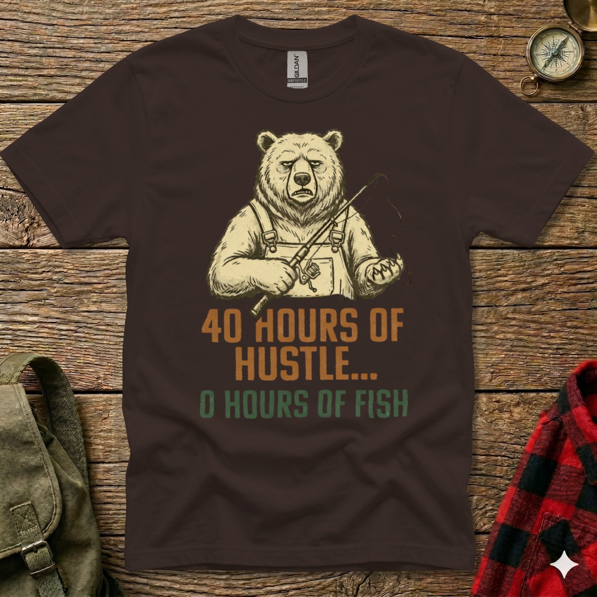 Brown t-shirt with graphic of a bear fishing, text reads "40 Hours of Hustle... 0 Hours of Fish".