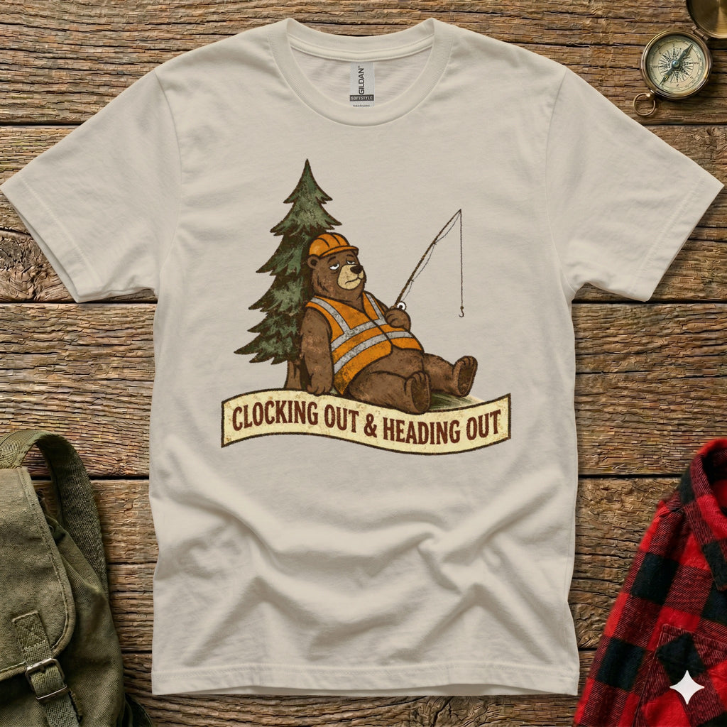 Bear wearing hard hat and vest fishes by tree, text reads "Clocking Out & Heading Out."
