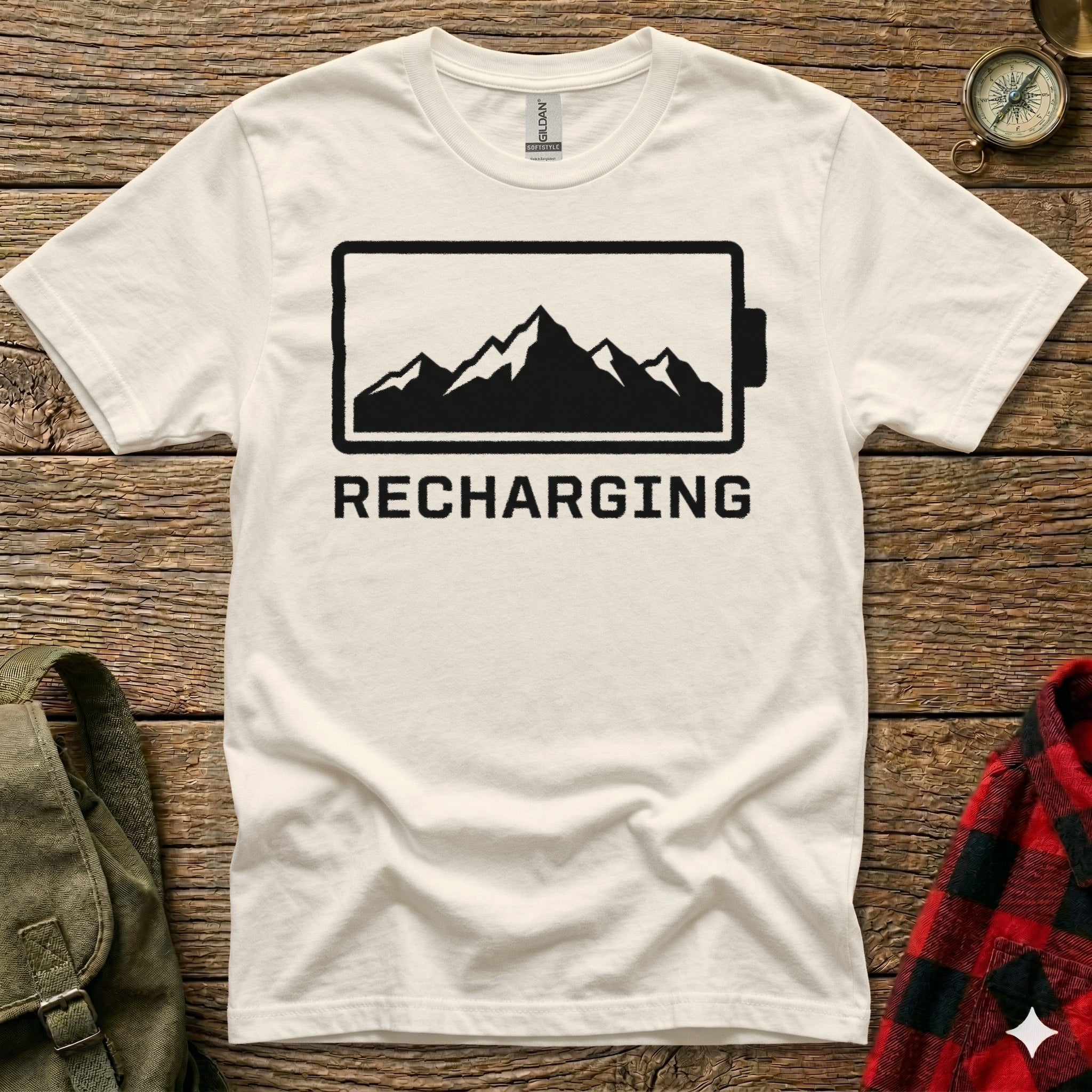 White t-shirt with "RECHARGING" text above mountain silhouette in battery icon.