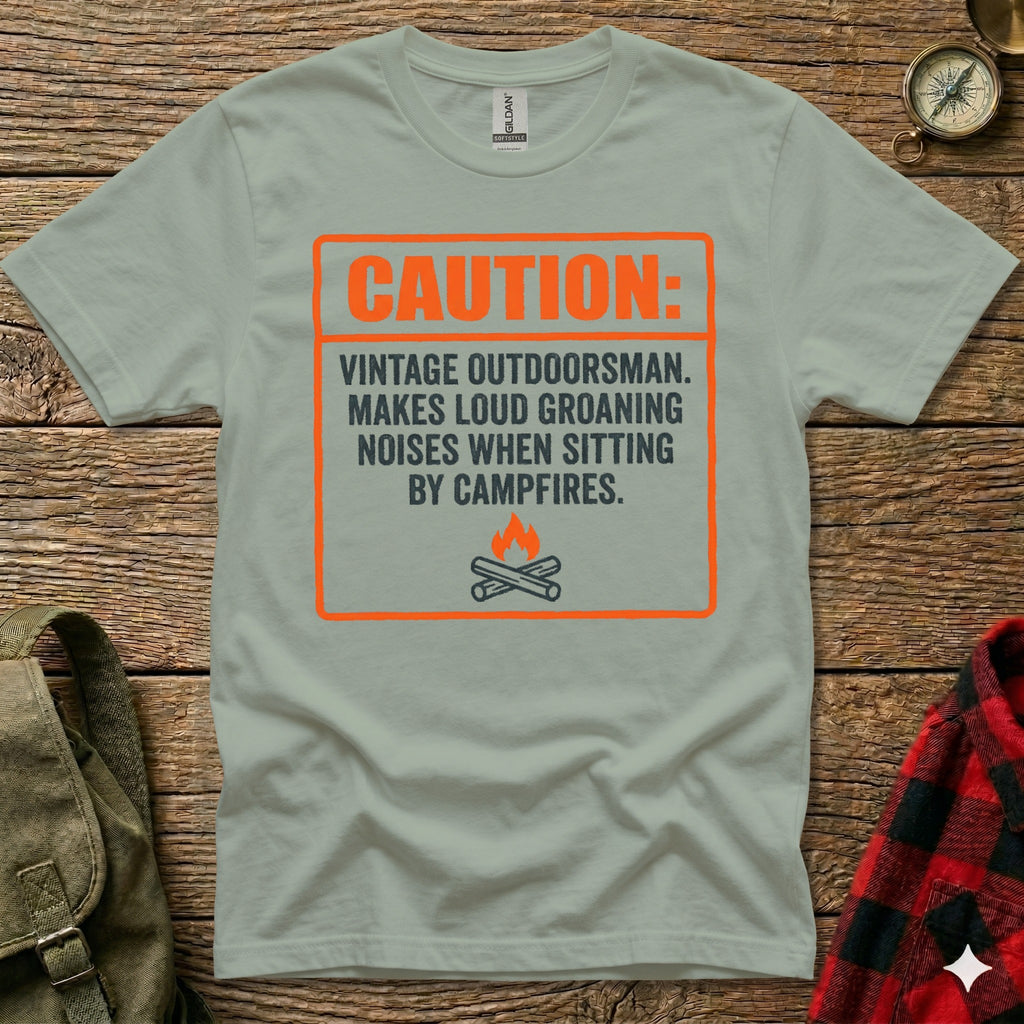 T-shirt with "CAUTION: VINTAGE OUTDOORSMAN..." text and campfire graphic.