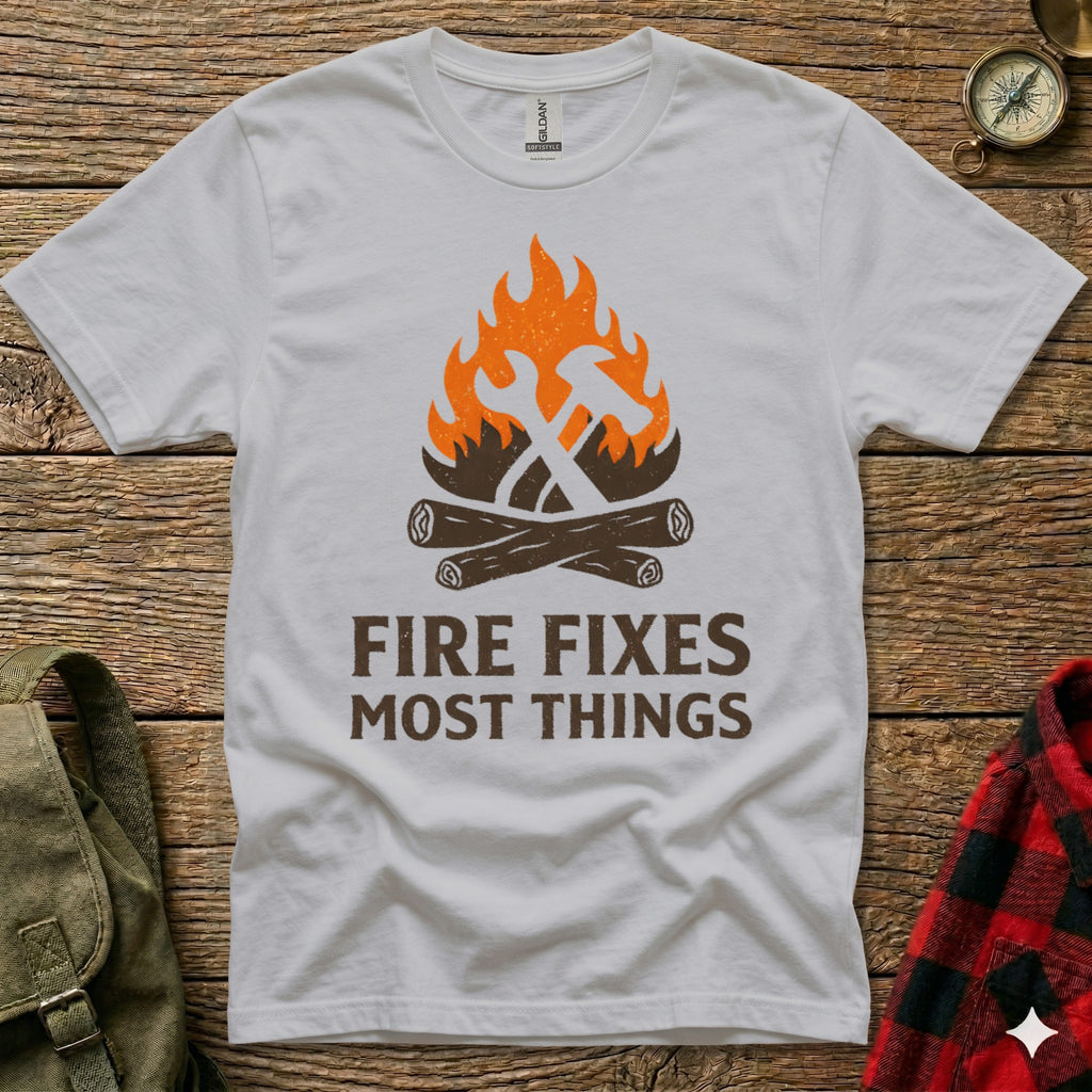 White t-shirt with hammer, axe, and fire graphic and "Fire Fixes Most Things" text.