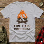 White t-shirt with hammer, axe, and fire graphic and "Fire Fixes Most Things" text.