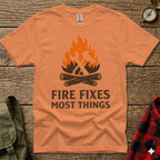 Orange t-shirt with crossed hammer and wrench above "FIRE FIXES MOST THINGS" text.