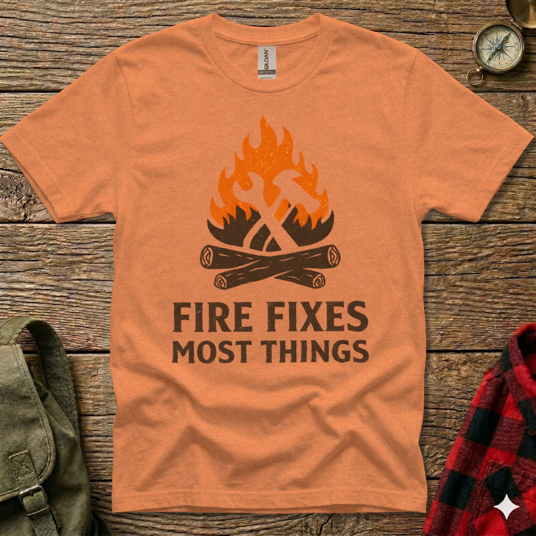Orange t-shirt with crossed hammer and wrench above "FIRE FIXES MOST THINGS" text.