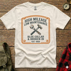 White t-shirt with "High Mileage Low Maintenance Blue Collar Est. 1950" and crossed tools graphic.