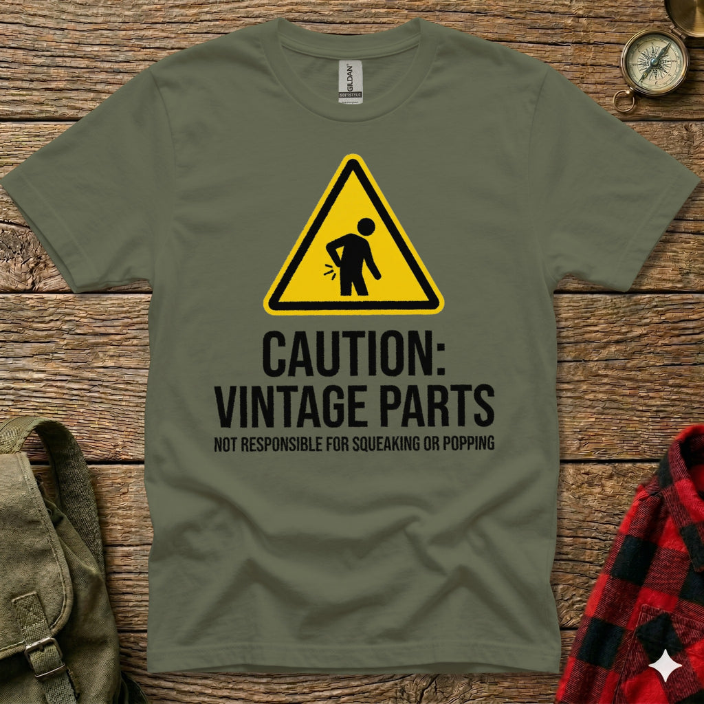 Olive green t-shirt with "CAUTION: VINTAGE PARTS" and warning symbol.