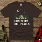 Dark brown t-shirt with "HARD WORK QUIET PLACES" text and forest scene.