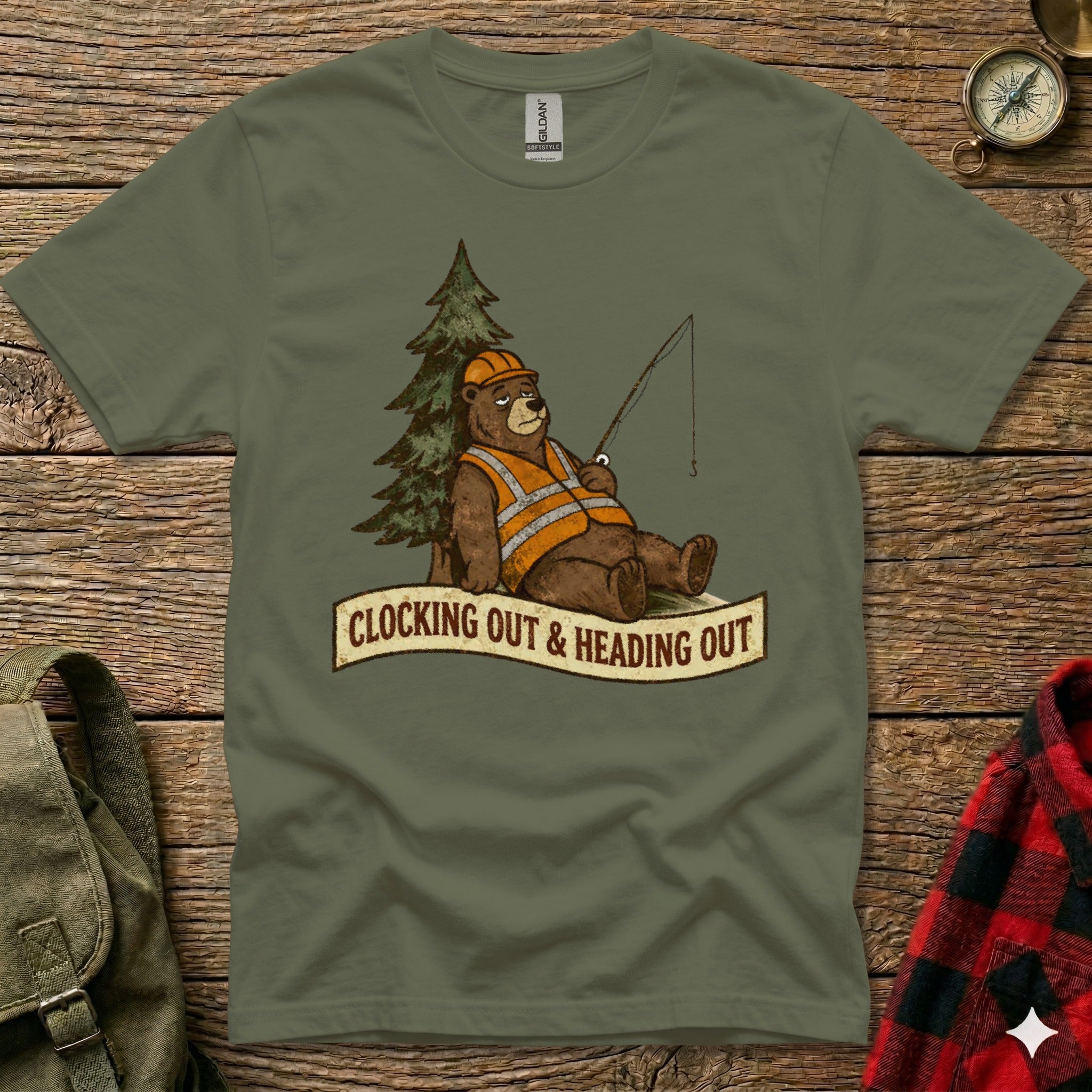 T-shirt with cartoon bear fishing, orange vest, hard hat, text "CLOCKING OUT & HEADING OUT".
