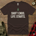 Brown t-shirt with "SHIFT ENDS. LIFE STARTS." text and a small tree graphic.