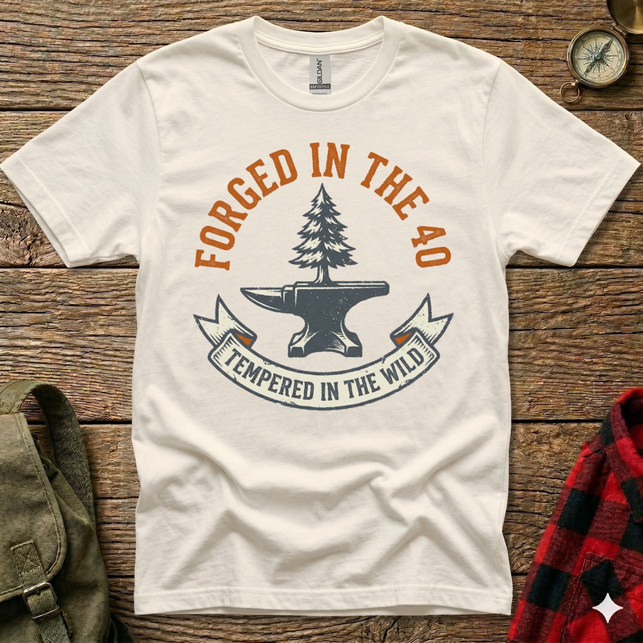 White t-shirt with "Forged in the 40, Tempered in the Wild" graphic.