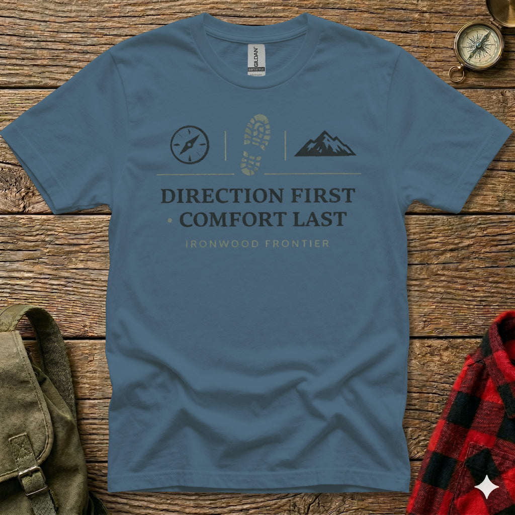 Blue t-shirt with hiking boot, mountain, and compass graphics and text.