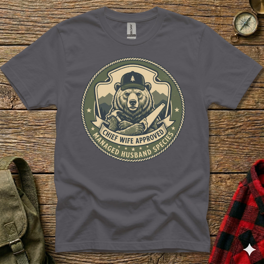 Bear wearing hat and holding saw, "Chief Wife Approved Managed Husband Species" text.