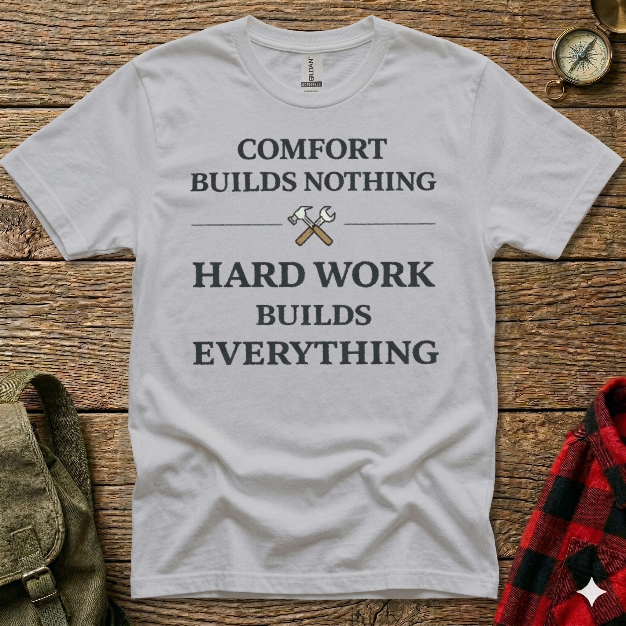 White t-shirt with text "COMFORT BUILDS NOTHING HARD WORK BUILDS EVERYTHING".
