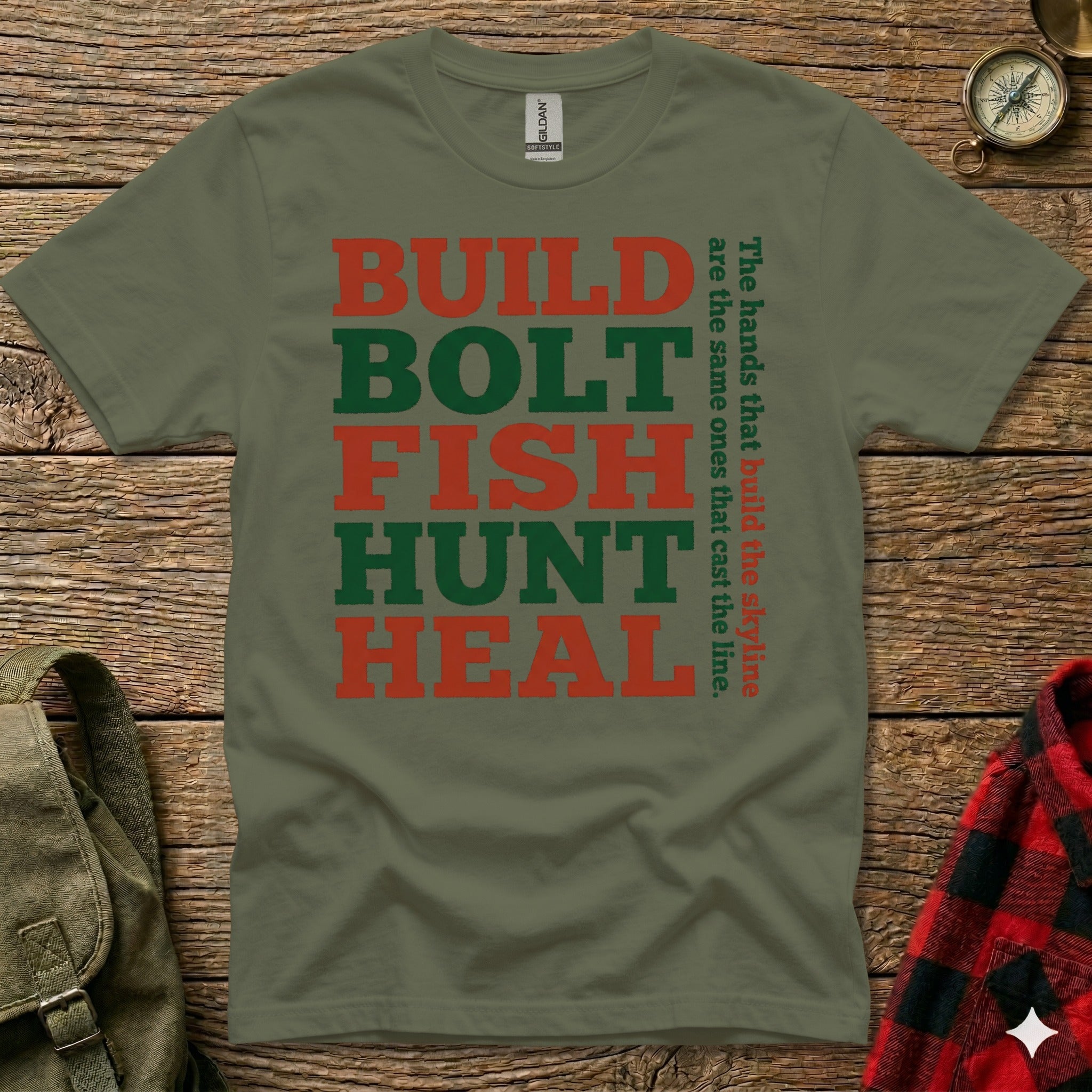 Green t-shirt with red text "BUILD BOLT FISH HUNT HEAL" and tagline.