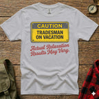 White t-shirt with "CAUTION TRADESMAN ON VACATION" sign and "Actual Relaxation Results May Vary" text.