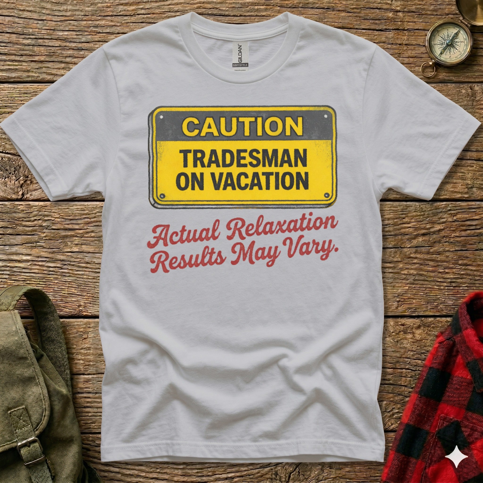 White t-shirt with "CAUTION TRADESMAN ON VACATION" sign and "Actual Relaxation Results May Vary" text.