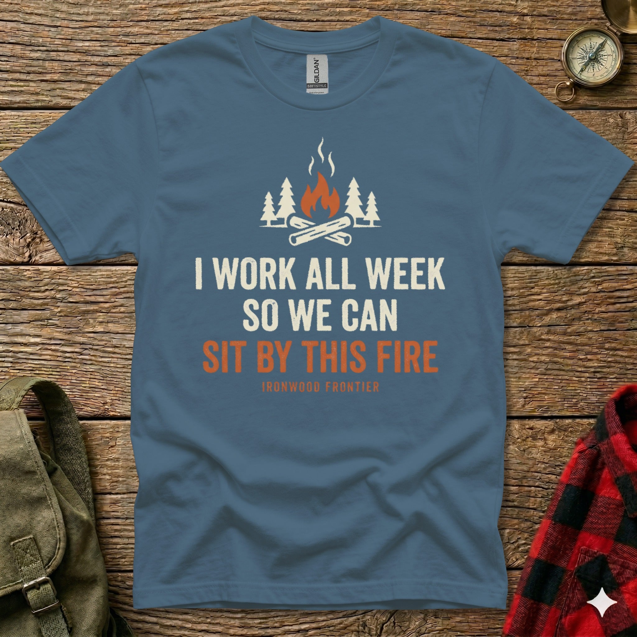 Blue t-shirt with text "I WORK ALL WEEK SO WE CAN SIT BY THIS FIRE" and campfire graphic.