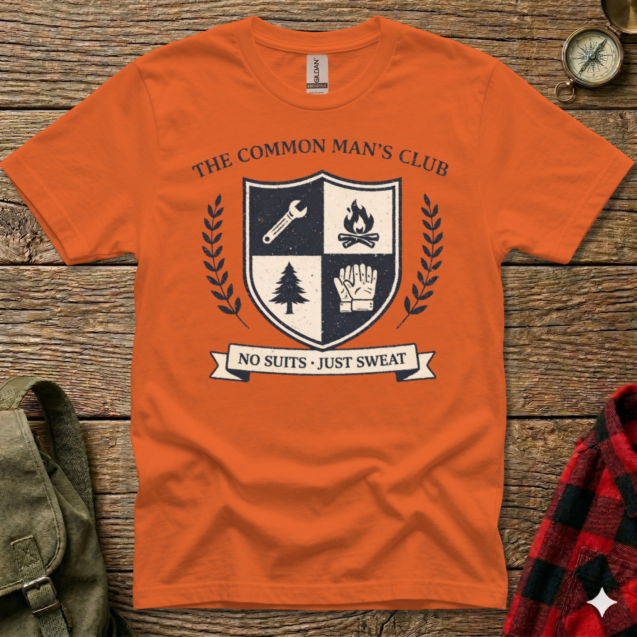 Orange t-shirt with "The Common Man's Club" crest and motto "No Suits. Just Sweat."