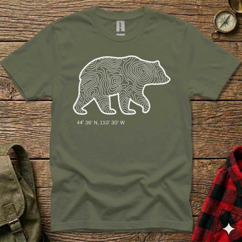 Olive green t-shirt with white bear outline, topographic lines, and coordinates.