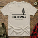 Cream t-shirt with black text and a simple tree graphic.