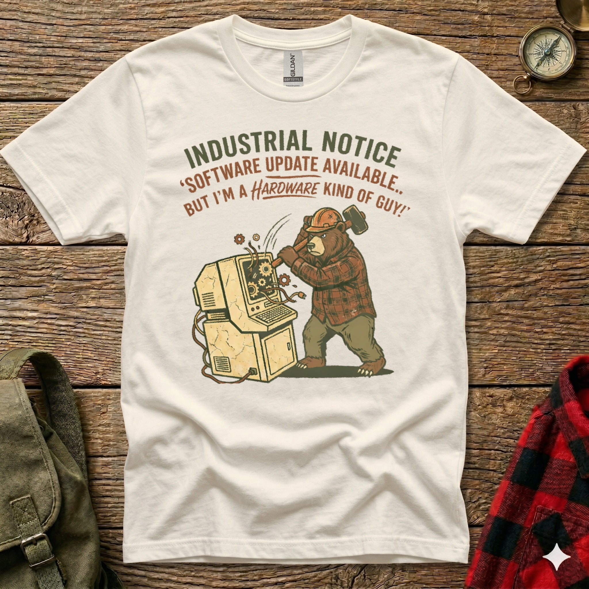Bear in flannel shirt smashes computer with hammer, "Software update available" text.