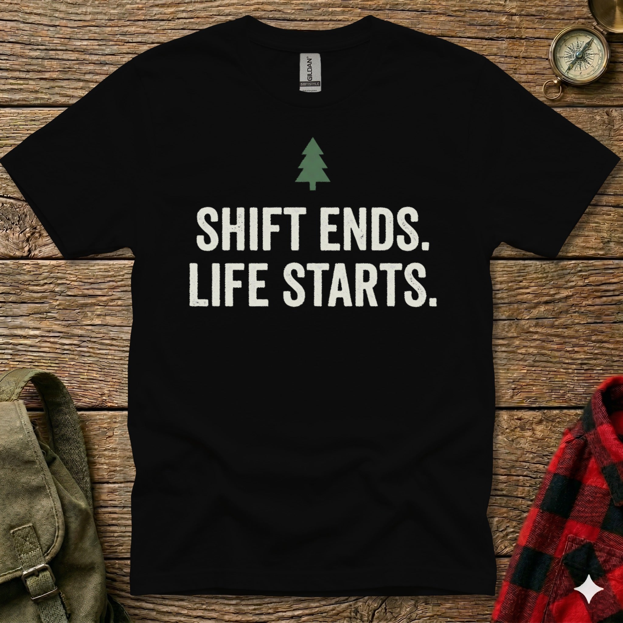 Black t-shirt with white text "SHIFT ENDS. LIFE STARTS." and a small green tree.