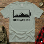 T-shirt with black battery icon and mountain silhouette, "RECHARGING" text.