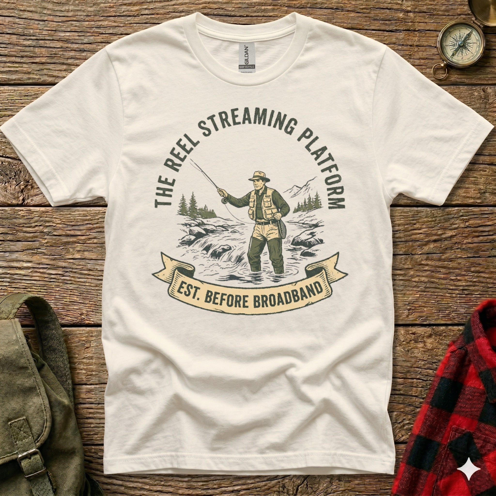 T-shirt graphic: Reel Streaming Platform logo with fisherman in river, est. before broadband.