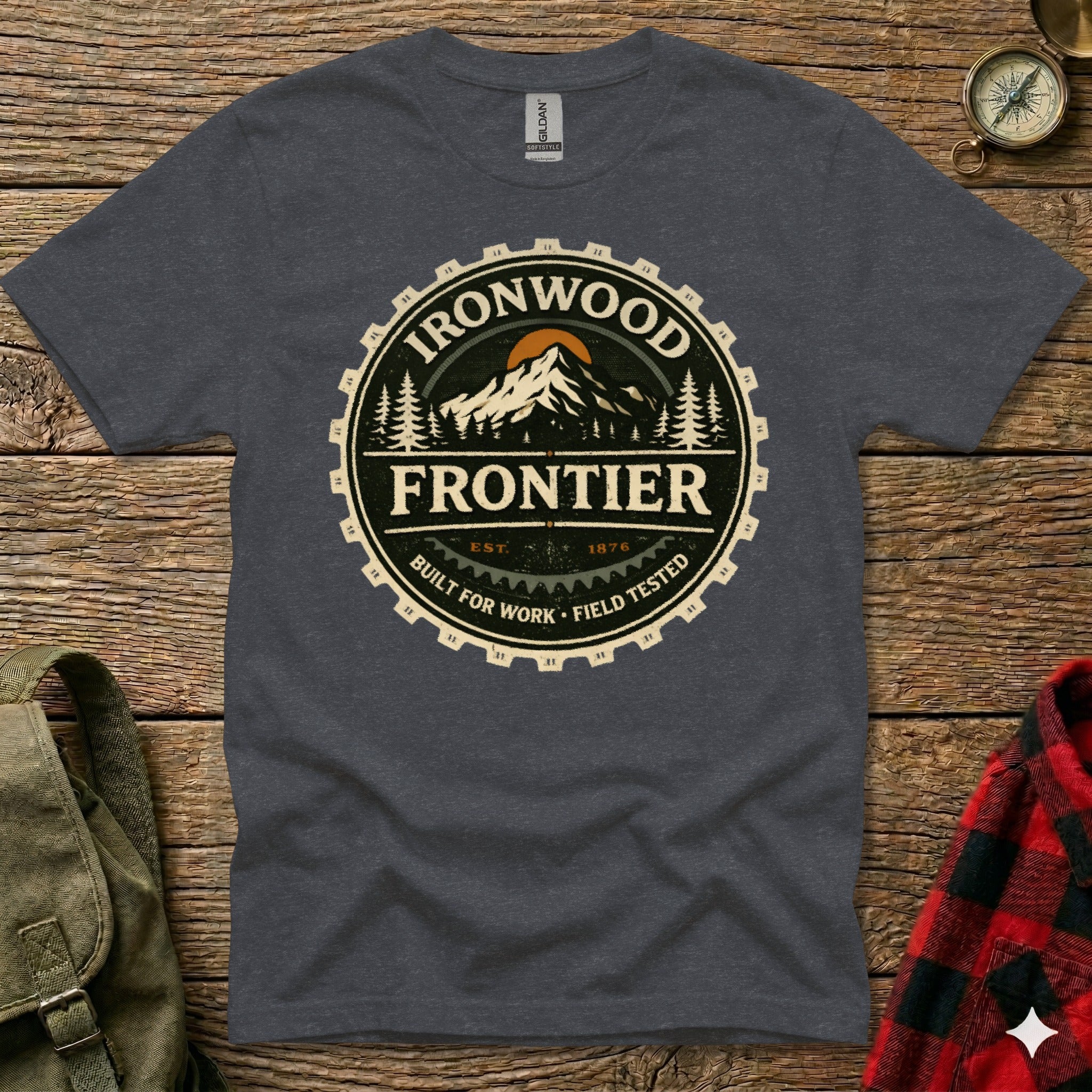 Dark grey t-shirt with circular Ironwood Frontier logo featuring mountains and gear teeth.