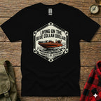 Black t-shirt with a graphic of a speedboat and text "Living on the Blue Collar Dollar Financed by Overtime".
