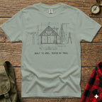 T-shirt with blueprint diagram of a lodge and text "BUILT TO SPEC, TESTED BY TRAIL".
