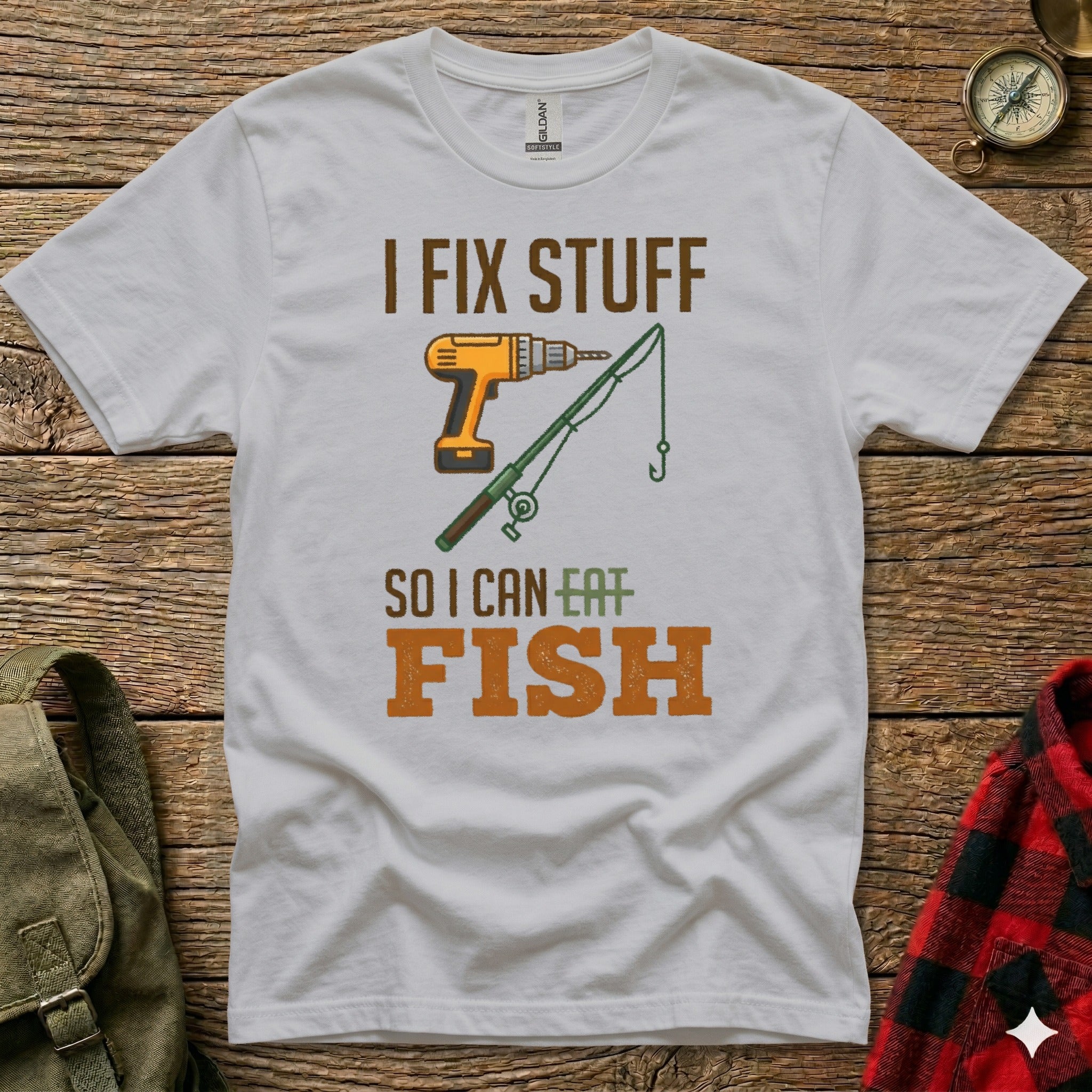 White t-shirt with drill, fishing rod, and text "I FIX STUFF SO I CAN EAT FISH".