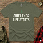 Olive green t-shirt with white text "SHIFT ENDS. LIFE STARTS." and a small green tree icon.
